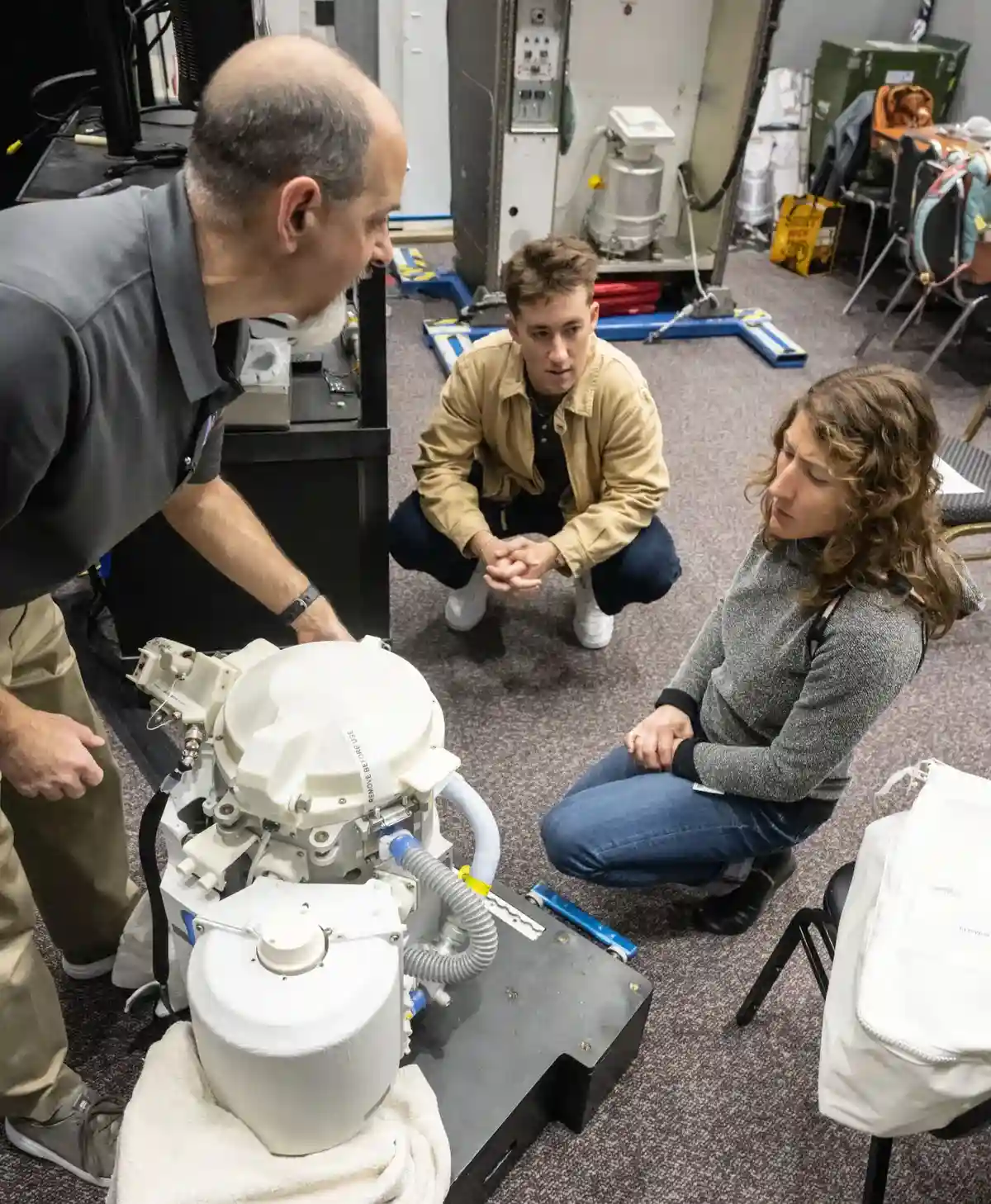 Christina Koch working with a test version of the Orion space toilet.